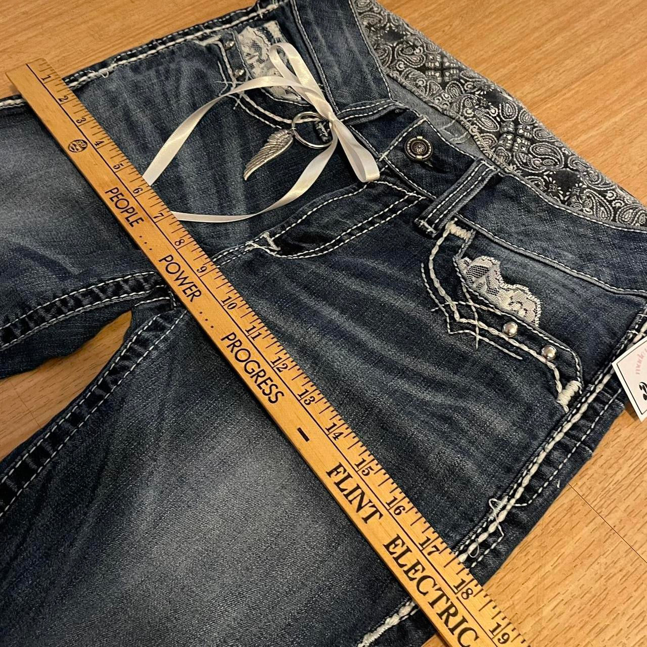 ୨୧ reworked y2k angel princess ooak white ribbon flare ariat jeans with thick contrast stitching, angel wing charm, studs, lace cuffs, lace trim & bows