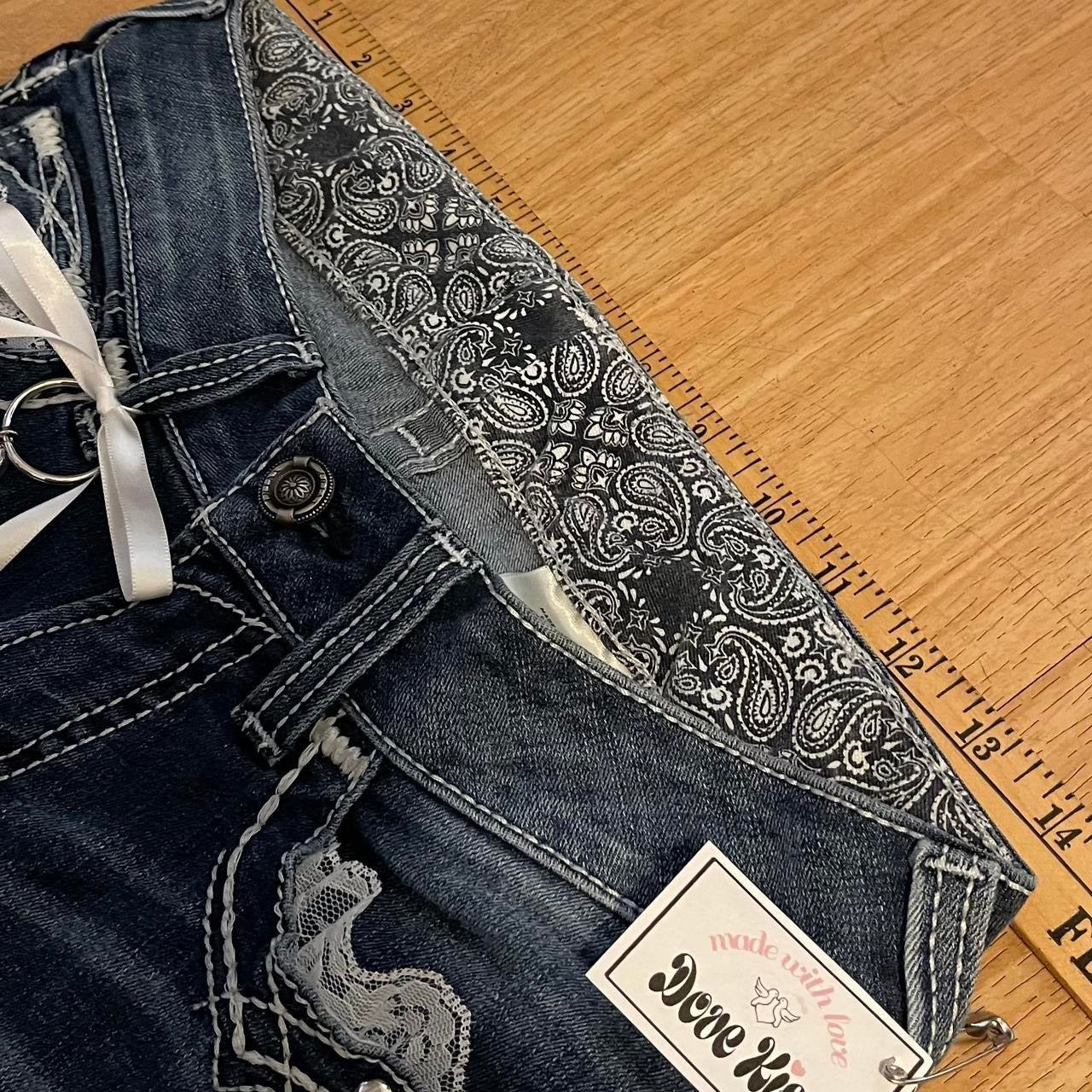 ୨୧ reworked y2k angel princess ooak white ribbon flare ariat jeans with thick contrast stitching, angel wing charm, studs, lace cuffs, lace trim & bows