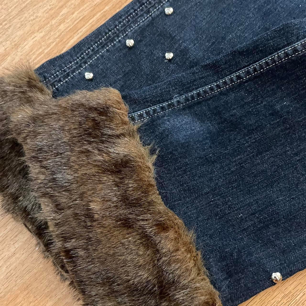 ୨୧ reworked y2k OOAK lowrise flare jeans with thick contrast stitching, eyelets, studs, faux fur cuffs + keychain, and faux leather lace up waist band