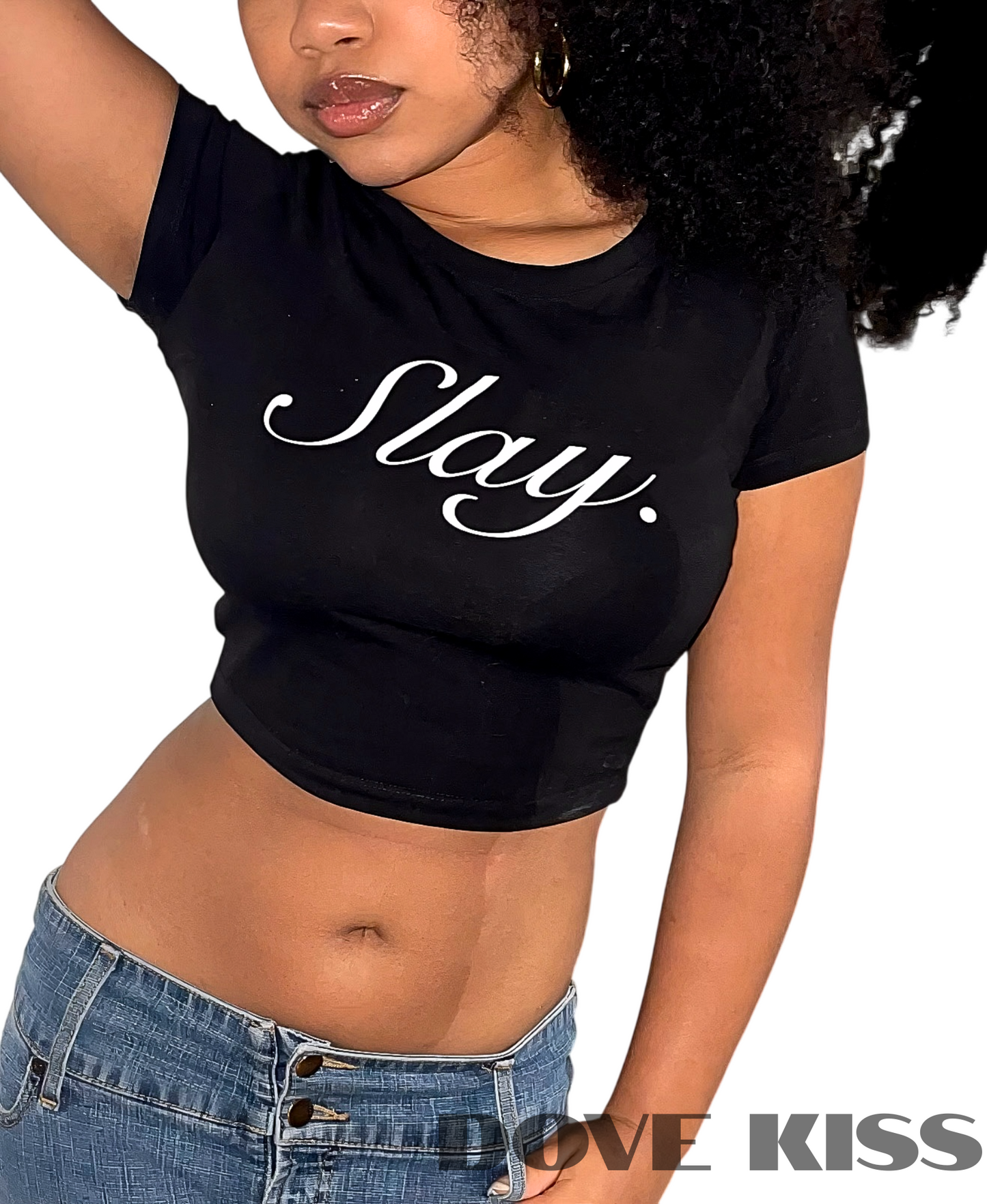 A woman wearing a black short-sleeve crop top with the word 'Slay.' printed in white script across the chest, paired with blue jeans against a plain white background.